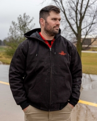 Man wearing Merschman Seeds Black Hooded Farm Jacket